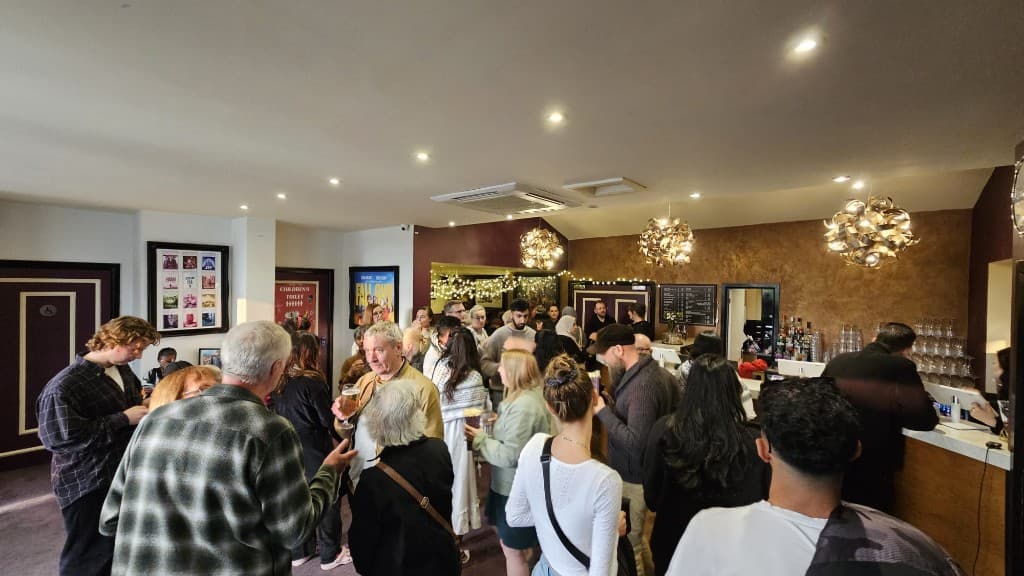 A crowded cinema bar during the festival, with people talking and drinks lined up on the counter